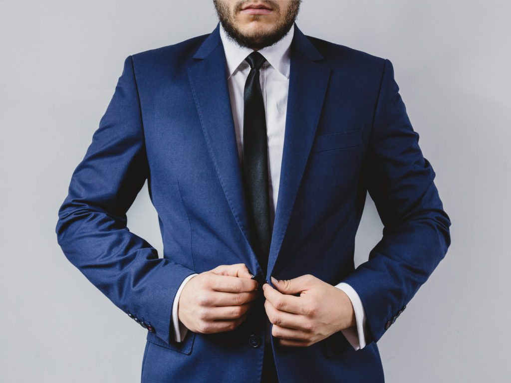 man putting on a suit