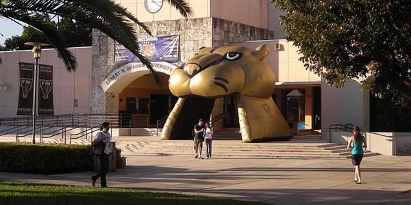 Outdoor view of college building and students walking