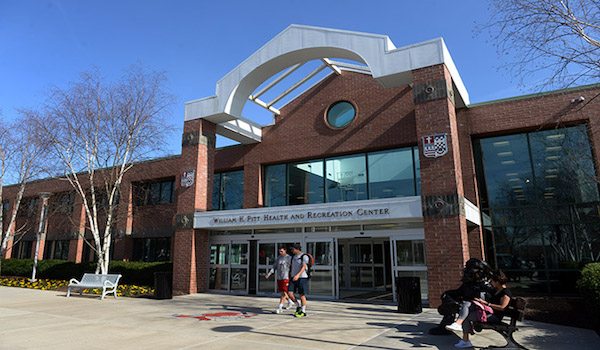 Outdoor view of college building and students walking