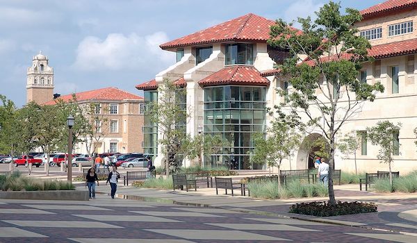 Outdoor view of college campus and students walking