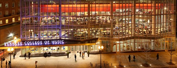 Berklee College of Music building at night with students walking outdoors