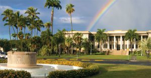 Outdoor view of college campus with rainbow in the sky