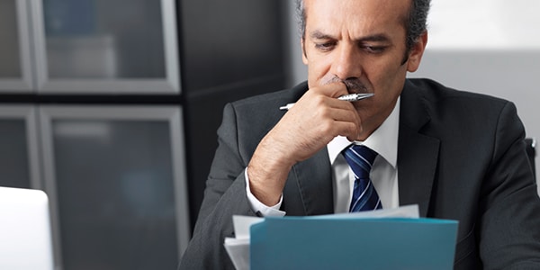 Healthcare compliance officer reviewing paperwork