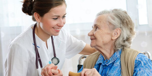 Licensed Practical Nurse taking care of senior female patient