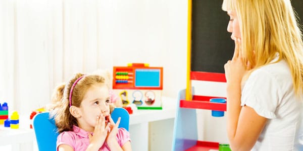 Speech language pathologist speaking to a child