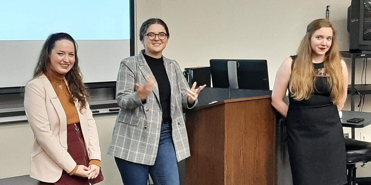 Female college students giving a presentation