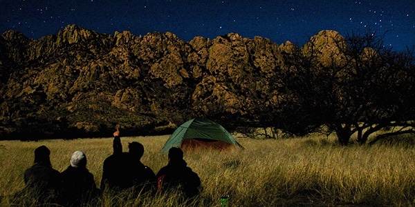 Illustration of campers stargazing at night