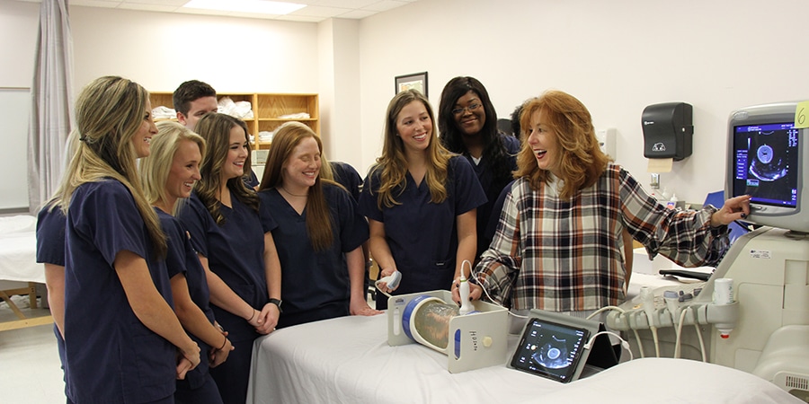 Group of college students viewing mock ultrasound of dummy fetus