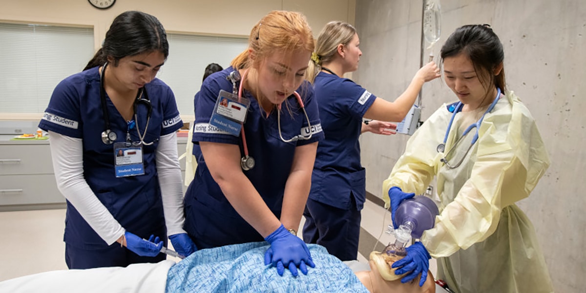 Healthcare students resucitating human dummy