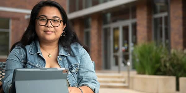 Female college student with building in the background