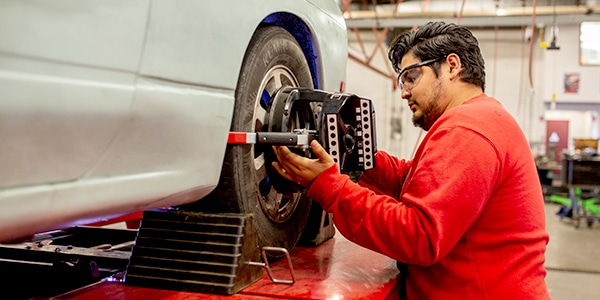 Student working on car wheel