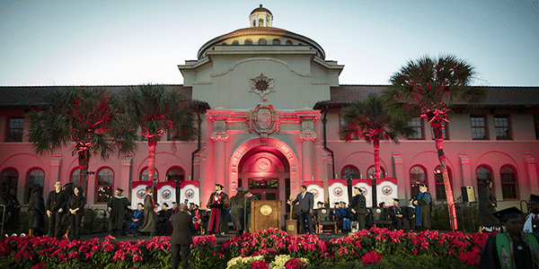 Stage for college graduation outdoors with faculty