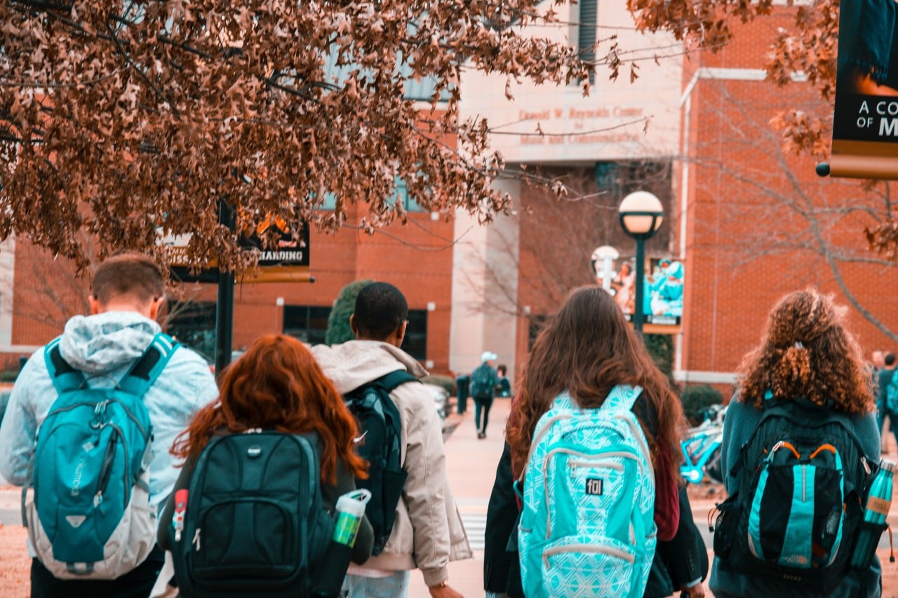 five students walking to college class