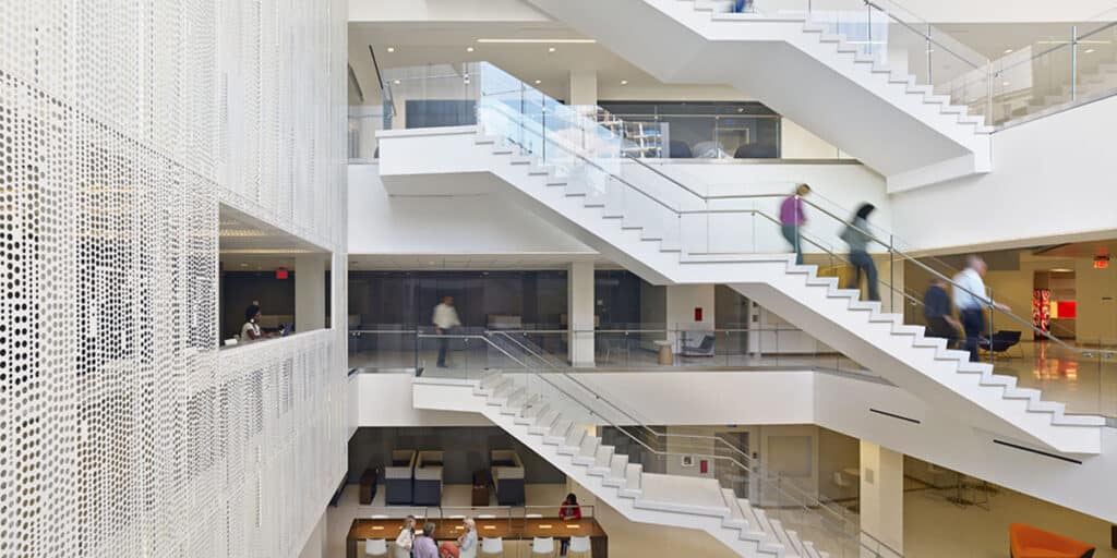 Students and faculty walking in college building