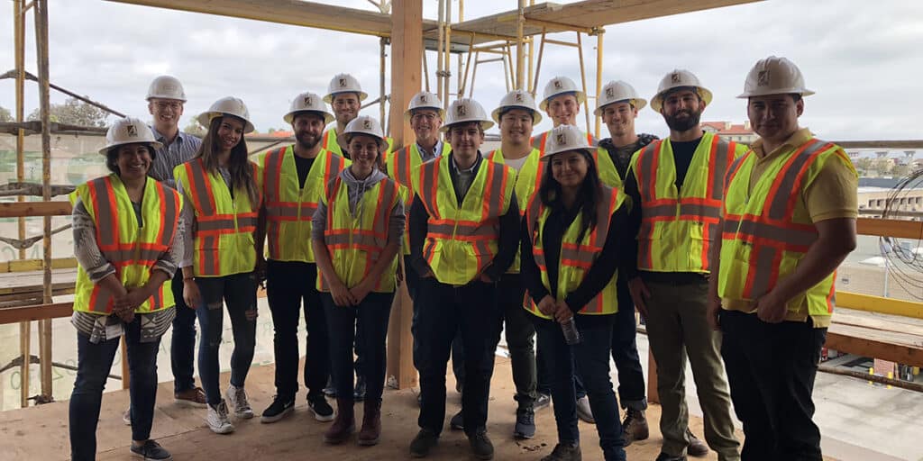 Group of college students standing on contruction site