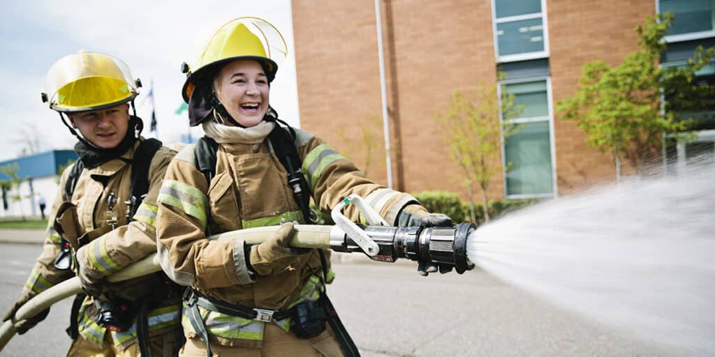 Firefighting students at Bates Technical College using hose outdoors