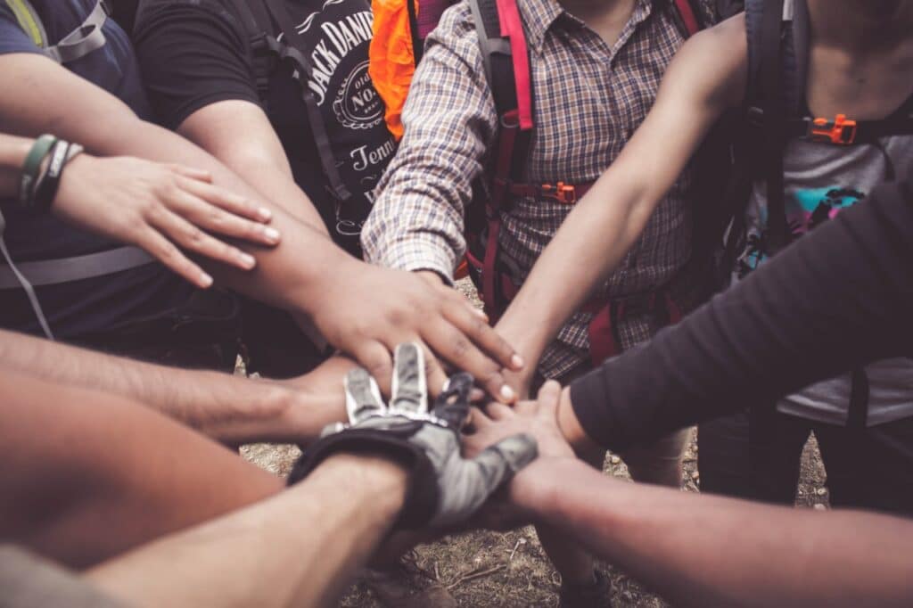 10 people all with their hands in a circle before they started community service